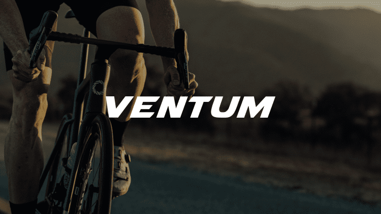 A close-up photo of a cyclist riding a bike with the Ventum logo prominently displayed.